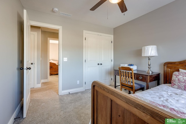 bedroom featuring a ceiling fan, visible vents, baseboards, a closet, and light colored carpet