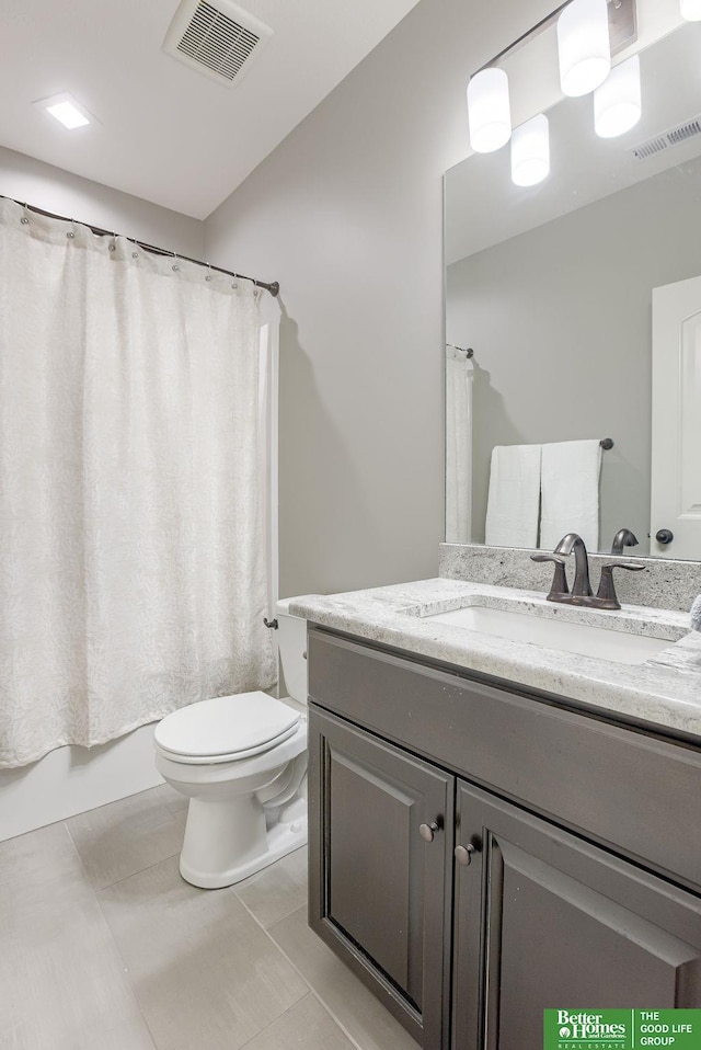 bathroom with vanity, toilet, visible vents, and tile patterned flooring