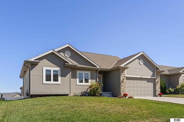 view of front of property with driveway, stone siding, an attached garage, and a front lawn