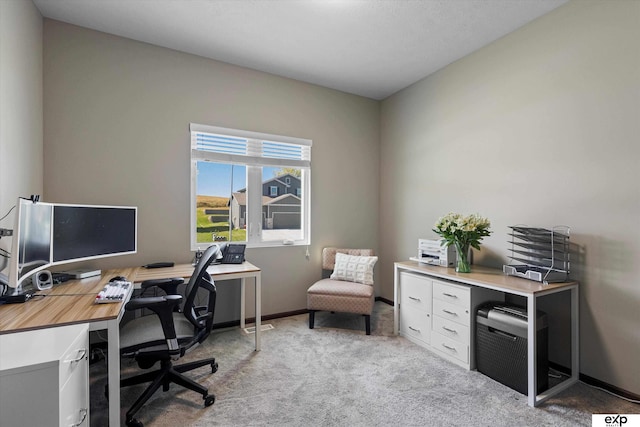 office with light carpet and baseboards