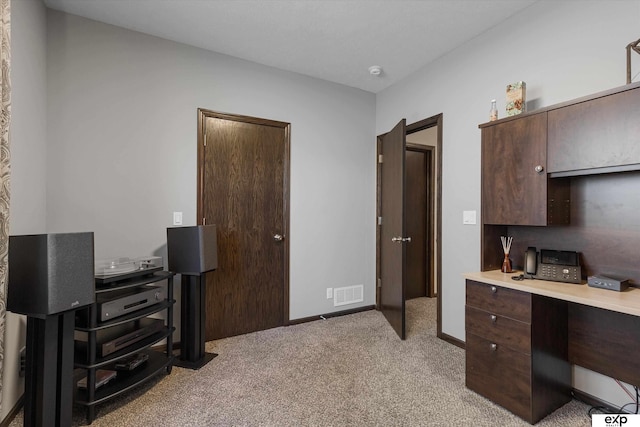 office featuring light colored carpet, visible vents, and baseboards