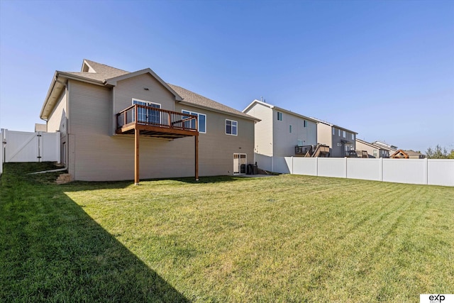 back of property with a fenced backyard and a yard