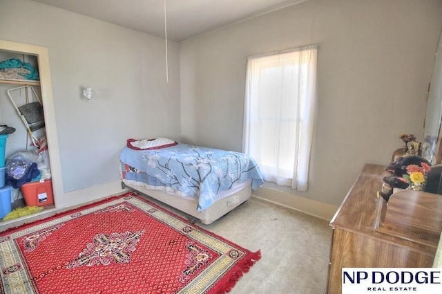 bedroom featuring carpet and baseboards