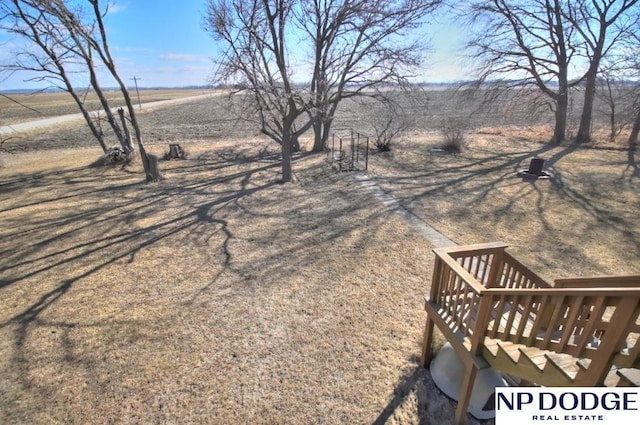 view of yard with a deck and a rural view