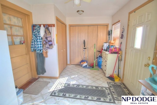 doorway with ceiling fan and light floors