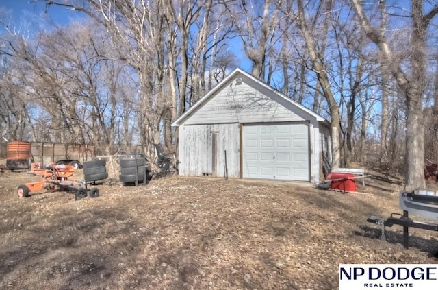 detached garage with dirt driveway