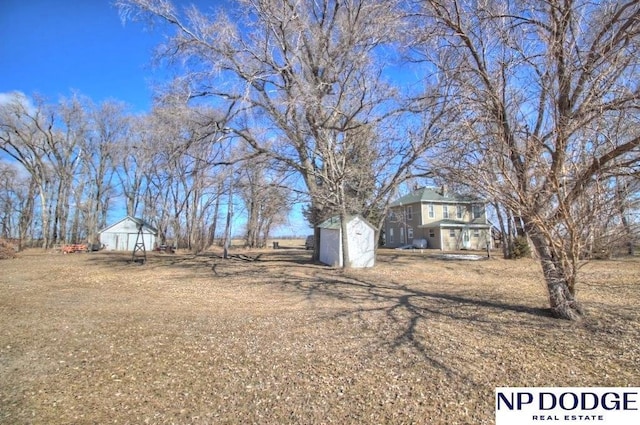 view of yard with an outdoor structure and a storage unit