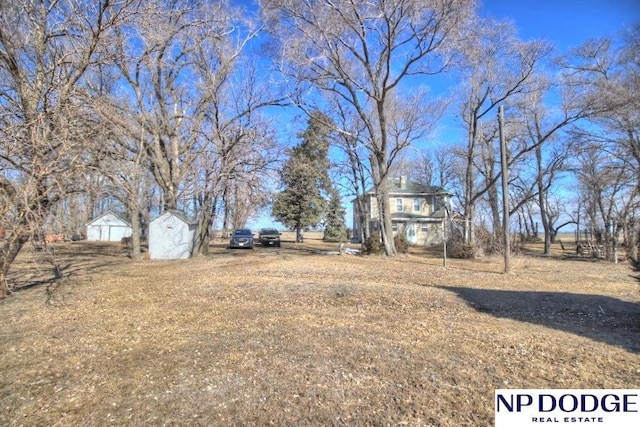 view of yard featuring an outbuilding and a storage unit