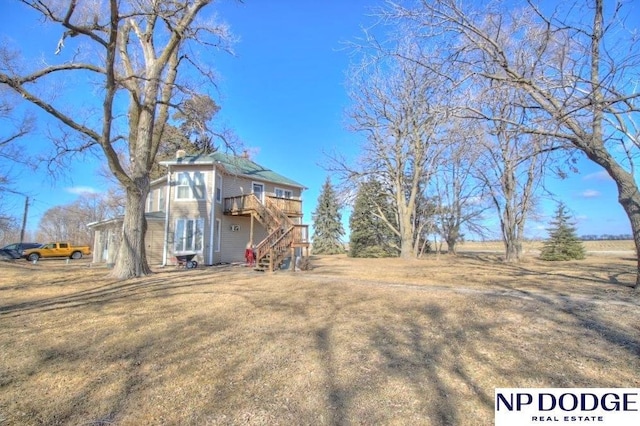 exterior space with a wooden deck and stairs