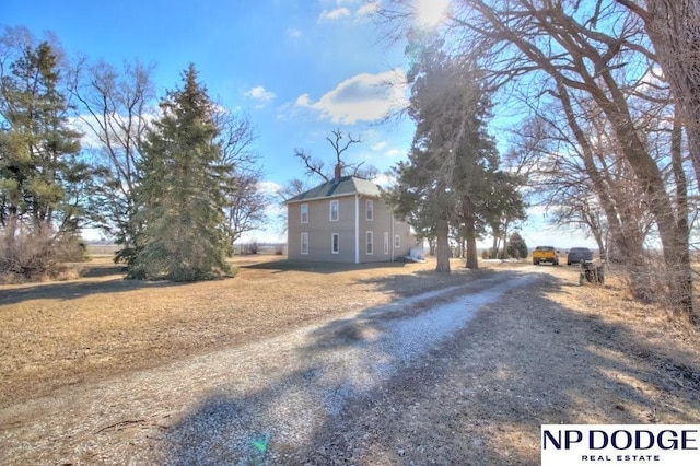 view of front facade with a rural view and driveway