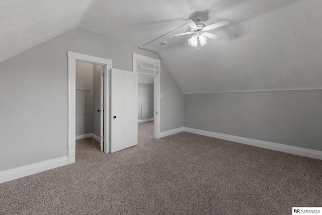 bonus room with vaulted ceiling, carpet floors, and baseboards