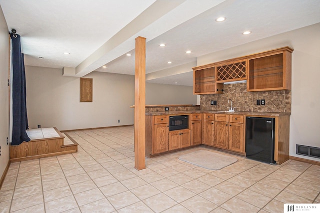 kitchen featuring black microwave, visible vents, fridge, open shelves, and tasteful backsplash