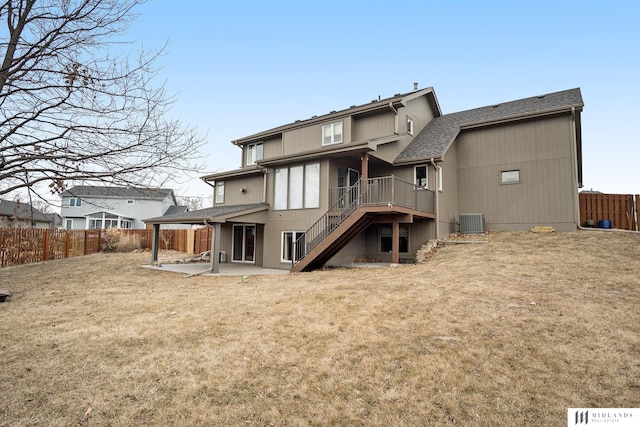 rear view of property with a patio area, a fenced backyard, stairs, and a yard