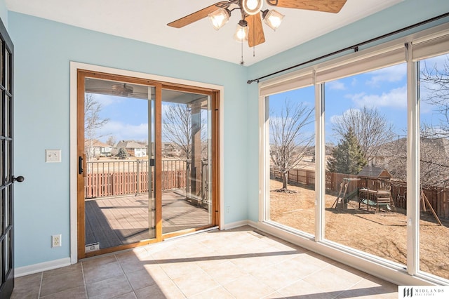 doorway to outside with tile patterned flooring, a residential view, baseboards, and a wealth of natural light