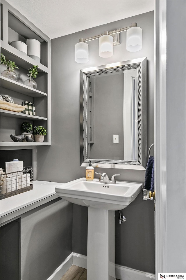 bathroom featuring baseboards and wood finished floors