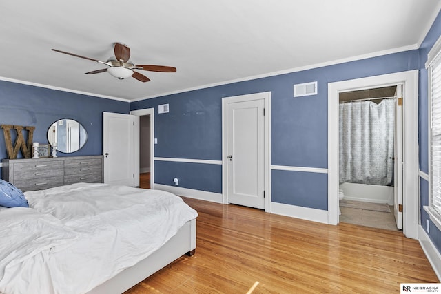 bedroom with wood finished floors, a ceiling fan, baseboards, visible vents, and crown molding