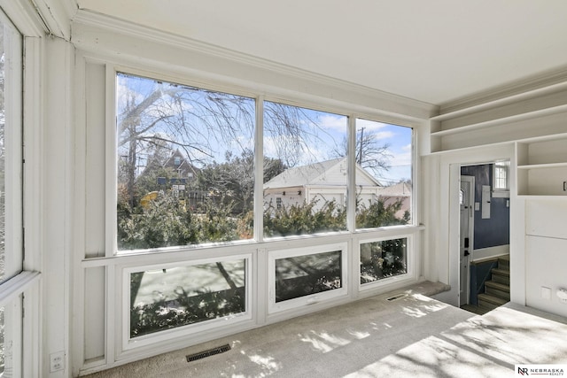 unfurnished sunroom with visible vents