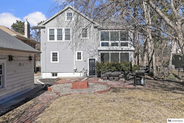 rear view of property with a patio area and a lawn