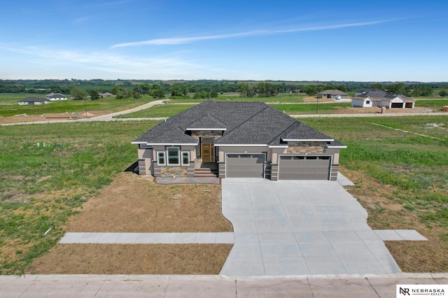 view of front of property featuring a garage, driveway, a shingled roof, and stone siding