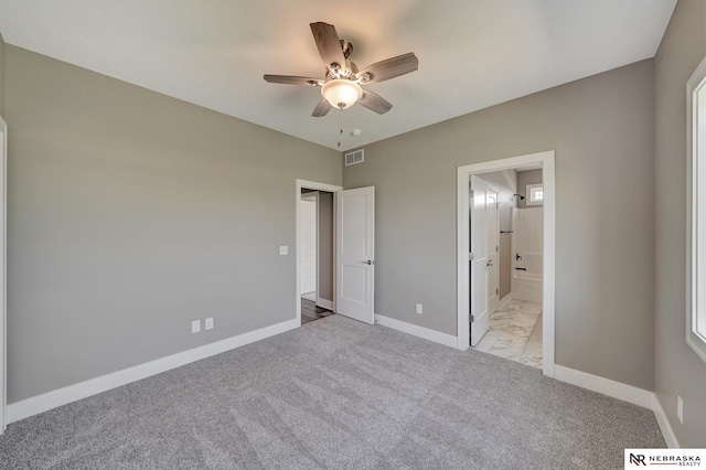 unfurnished bedroom featuring light carpet, connected bathroom, visible vents, and baseboards