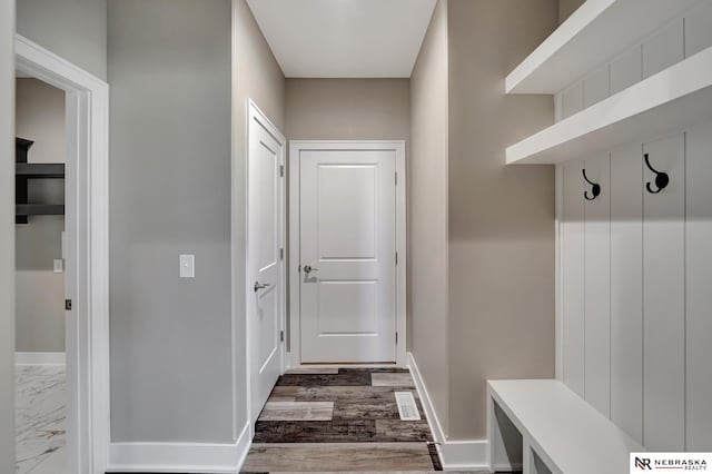 mudroom featuring marble finish floor and baseboards