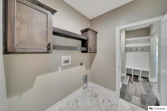 clothes washing area with washer hookup, marble finish floor, cabinet space, electric dryer hookup, and baseboards