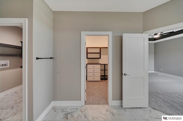 bathroom with marble finish floor, visible vents, and baseboards