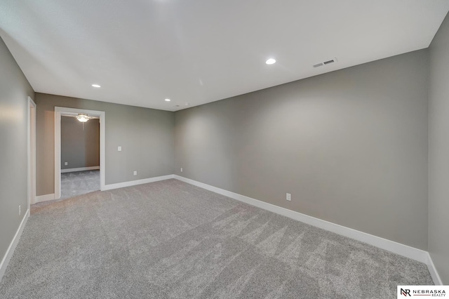 unfurnished room featuring carpet, visible vents, baseboards, and recessed lighting