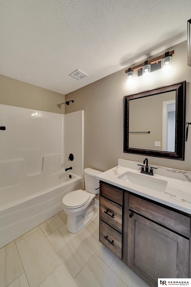 full bathroom with visible vents, toilet, a textured ceiling, vanity, and shower / washtub combination