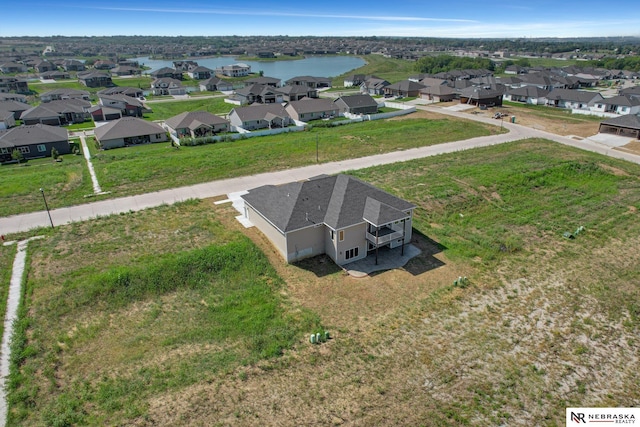 bird's eye view featuring a water view and a residential view