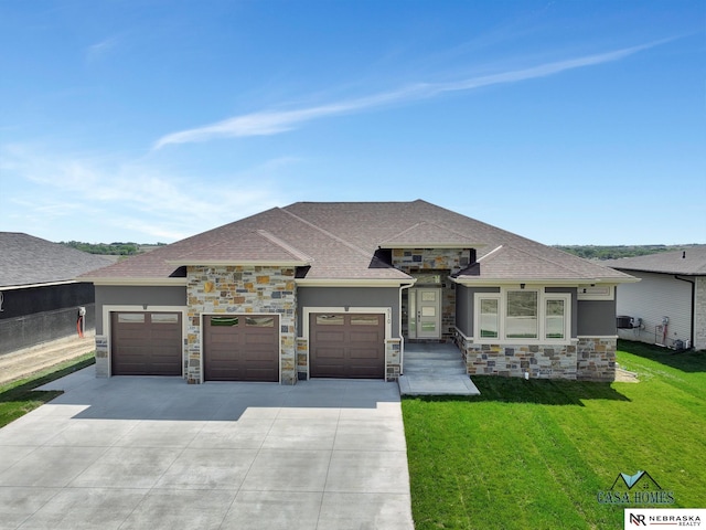 prairie-style house with driveway, a front lawn, an attached garage, and stucco siding