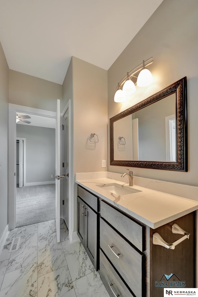 bathroom featuring marble finish floor, vanity, and baseboards