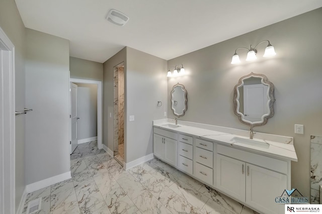 full bathroom featuring marble finish floor, double vanity, a sink, and baseboards