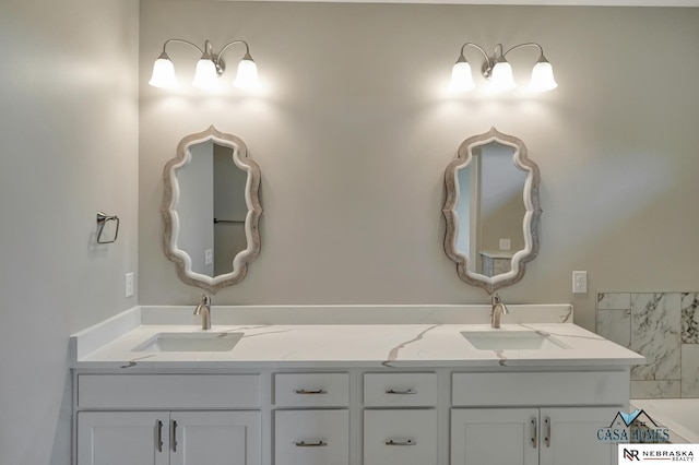 full bathroom featuring double vanity and a sink