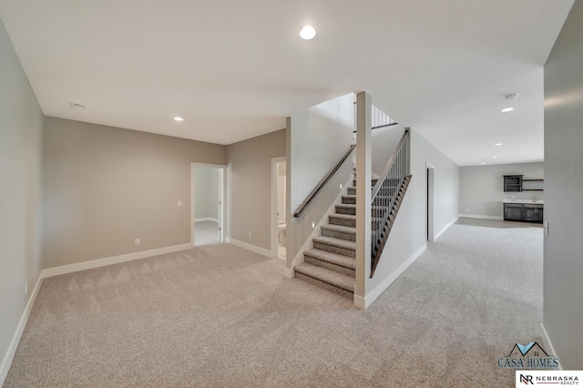 stairs with carpet, baseboards, and recessed lighting