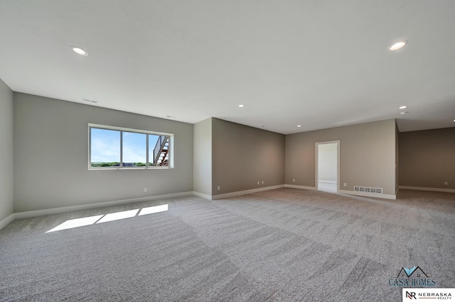 spare room with recessed lighting, baseboards, visible vents, and light colored carpet