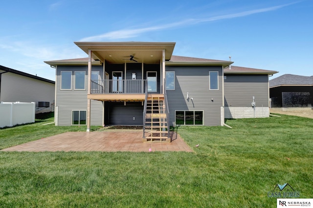 rear view of property with ceiling fan, a patio, stairway, and a lawn