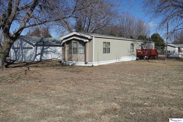 view of side of home with a lawn