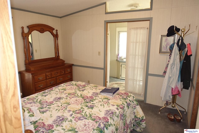 bedroom with carpet, ornamental molding, and vaulted ceiling