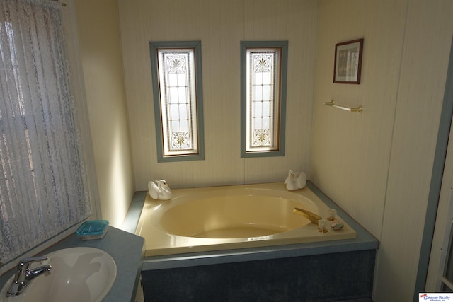 bathroom featuring a sink and a bath