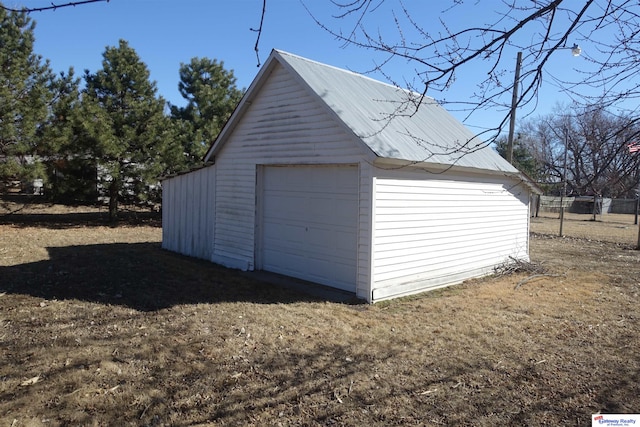 detached garage featuring driveway