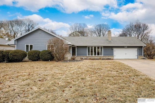 single story home featuring a garage, a shingled roof, concrete driveway, a chimney, and a front lawn