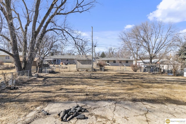 view of front of property with a residential view and fence