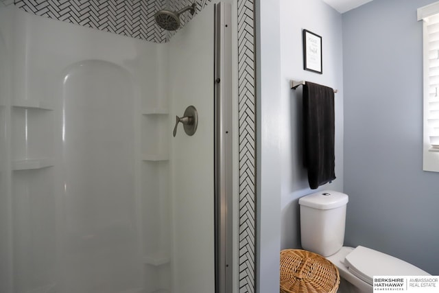 bathroom with a shower, a closet, and toilet