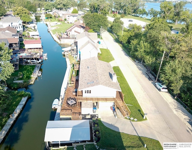 drone / aerial view featuring a residential view and a water view