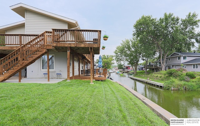 exterior space with a patio, stairway, and a deck with water view