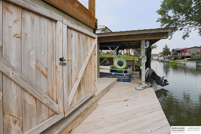 dock area with a water view and boat lift