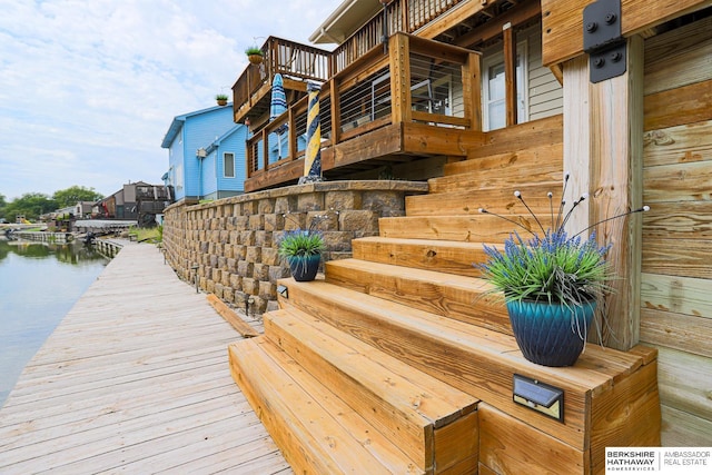 view of dock with a water view and stairs