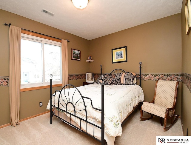 carpeted bedroom featuring visible vents and baseboards