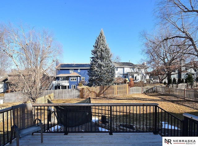 wooden terrace featuring a residential view and fence